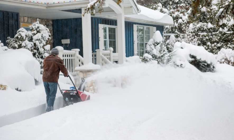 Person snow blowing their front yard