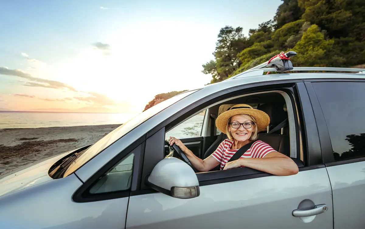 a woman at peace knowing she is protected by the AARP Auto Insurance Program from The Hartford