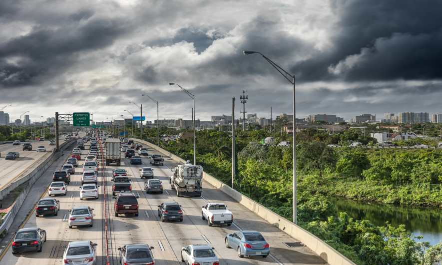 Stormy skies above a highway full of cars
