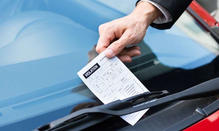 Person giving out a parking ticket