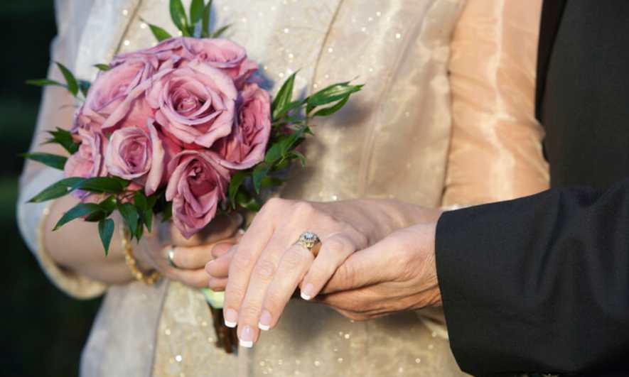 A middle-aged bride wearing an engagement ring