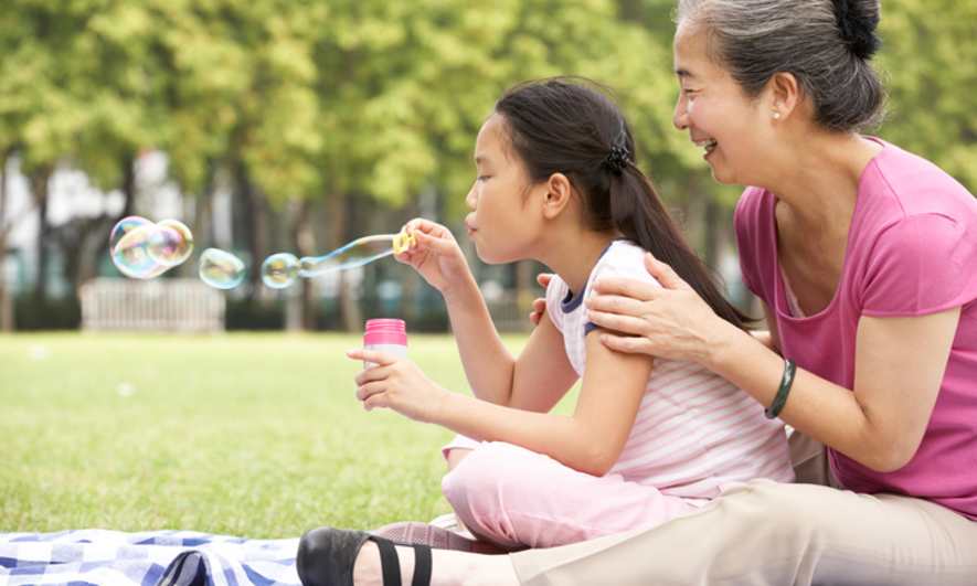 Grandmother and Grandchild Blowing Bubbles