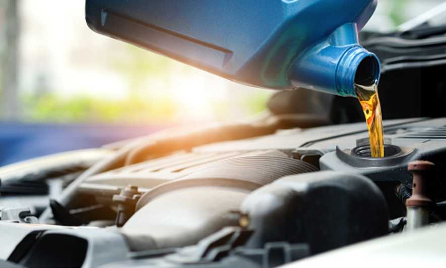 Pouring oil into a car