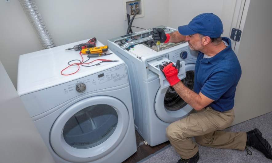 Maintenance working on a washing machine