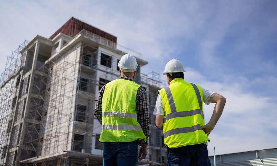 two men inspecting a construction site 