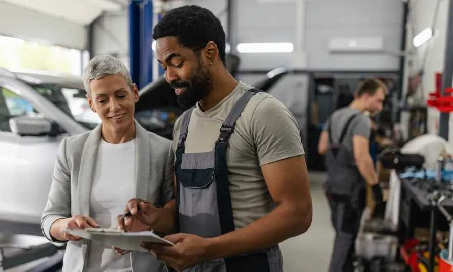 female customer pleased with auto repair shop employee's work