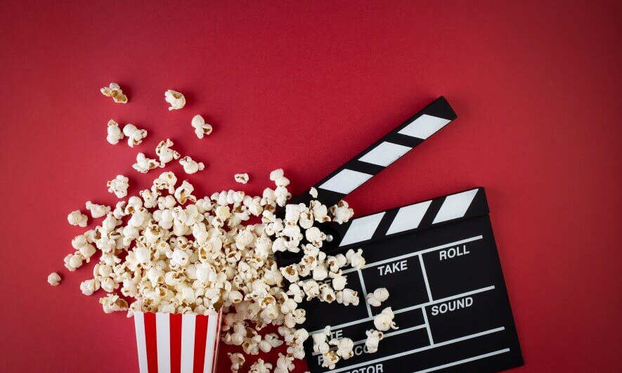 red background with popcorn and clapperboard