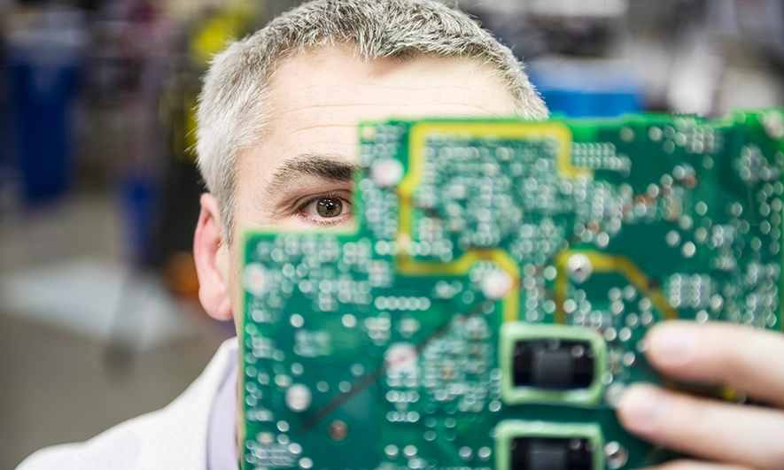 A technology worker stands in a server room