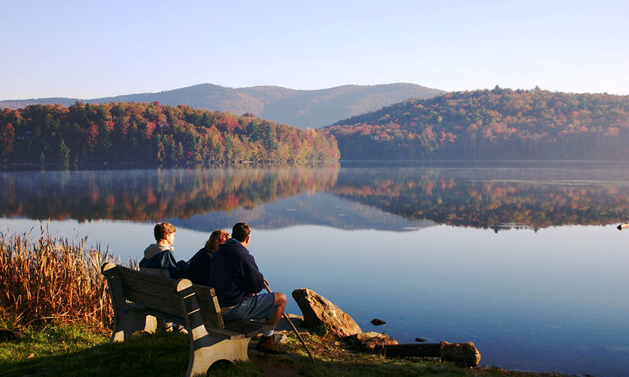3 people looking across lake