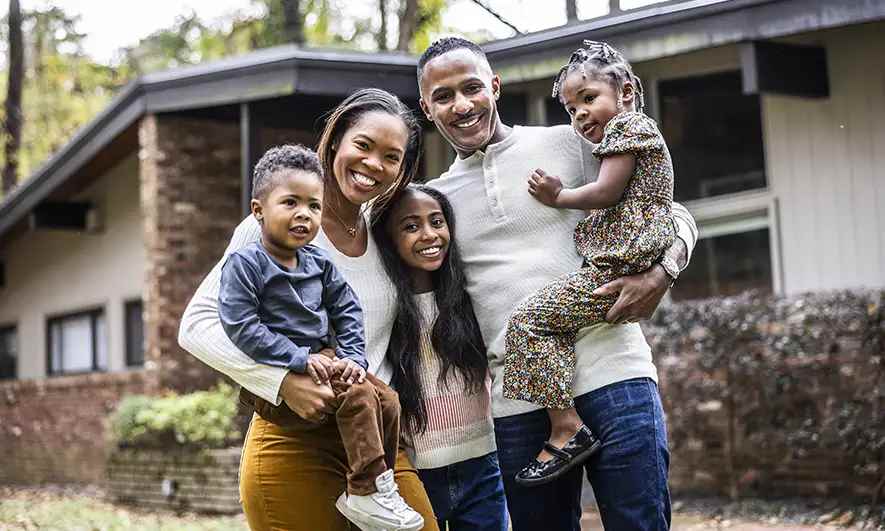 mom dad son looking at computer