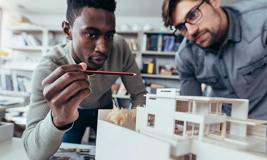 Architects and Engineers studying a building model