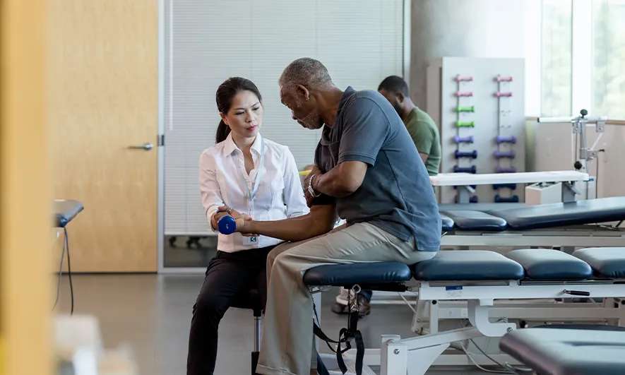 A physical therapist working with a patient