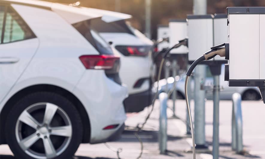 Electric cars plugged into a charging station