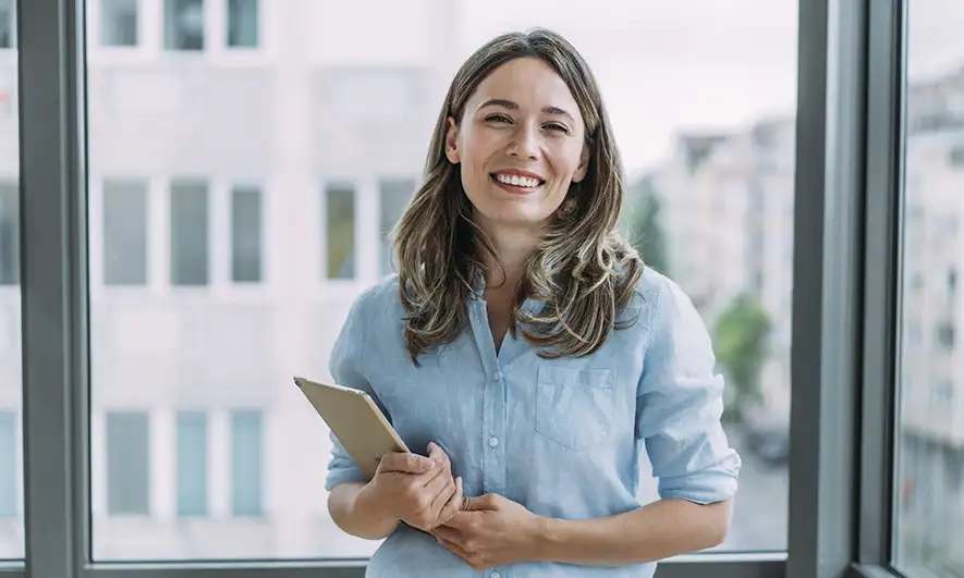 woman in an office holding a tablet