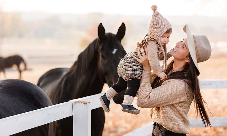 Mom and young child on a horse ranch