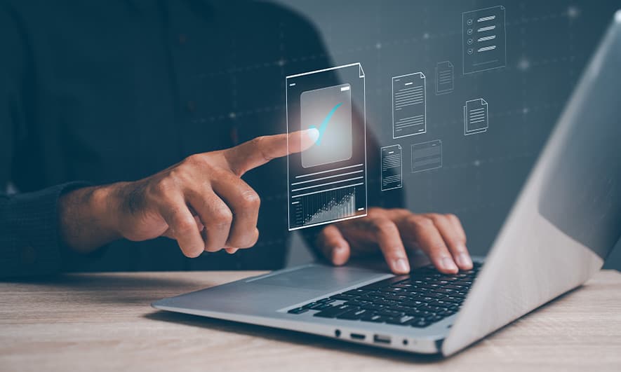 Close-up photo of hands typing on a laptop computer