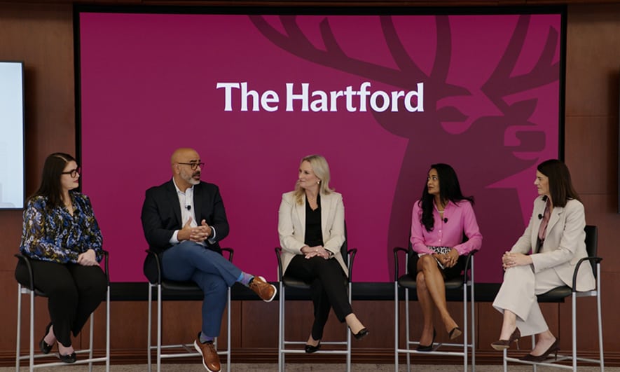 A panel of speakers on a stage