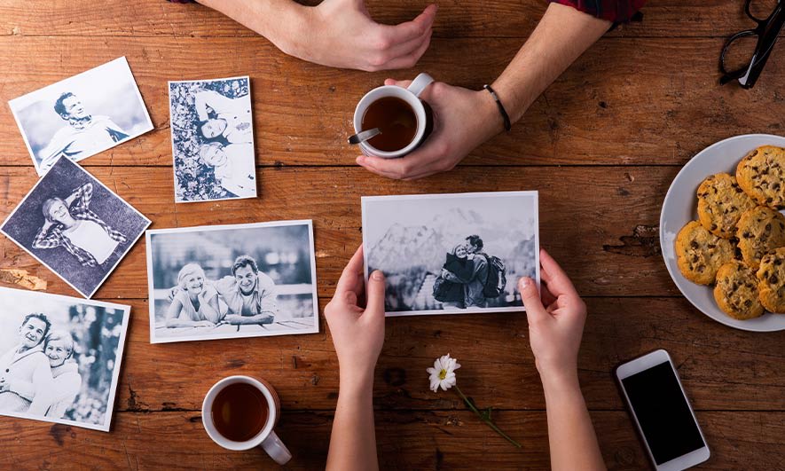Two people looking through photographs of a loved one