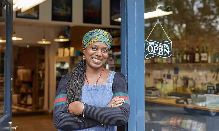 female small business owner happy to have the best workers comp insurance from The Hartford