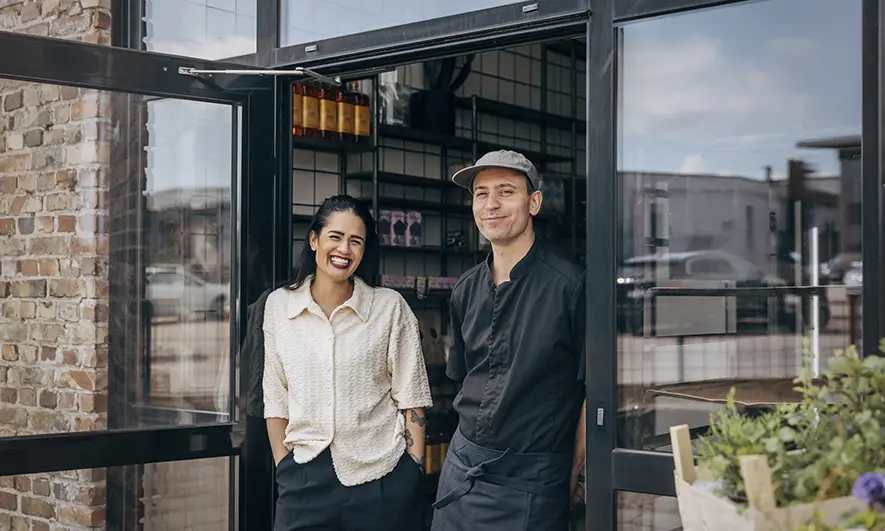 female and male business owners happy to have the best workers comp insurance for small business