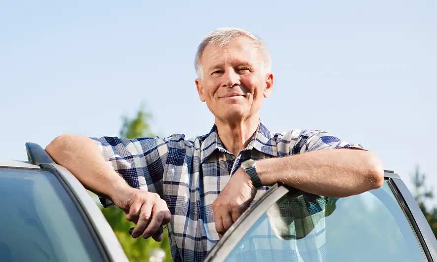 male driver happily protected by comprehensive car insurance