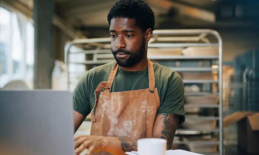 male small business owner protected by cyber crime insurance