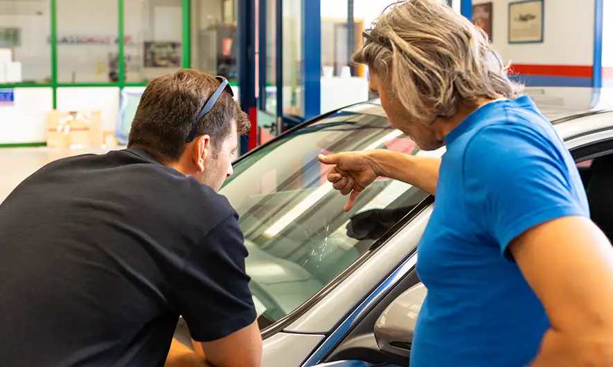 woman pleased knowing does insurance cover cracked windshield