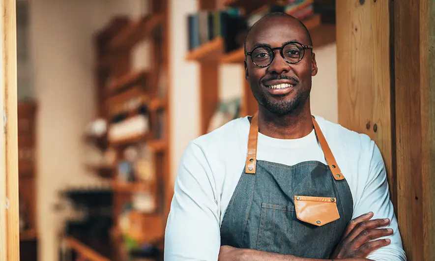 small business owner happy to know the differences between The Hartford vs. Hiscox