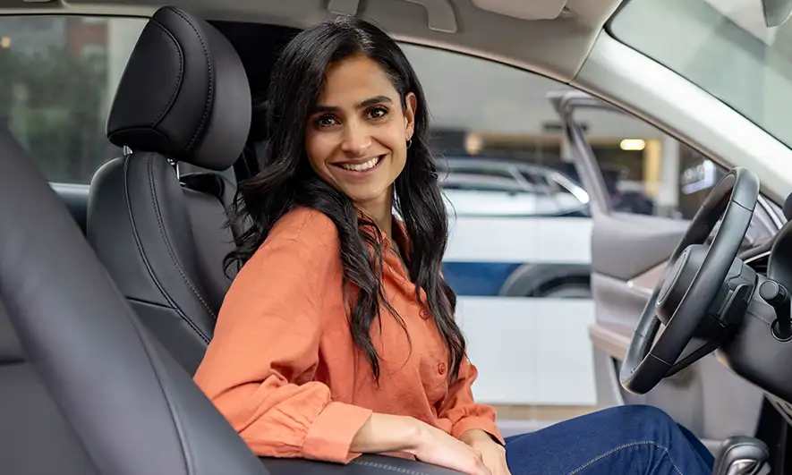 woman happy to have Uninsured Motorist Bodily Injury (UMBI) Insurance Coverage from The Hartford