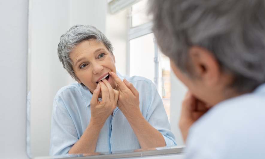 Woman Flossing