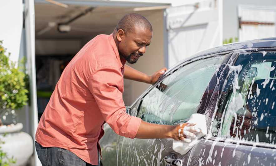 Person washing a car by hand