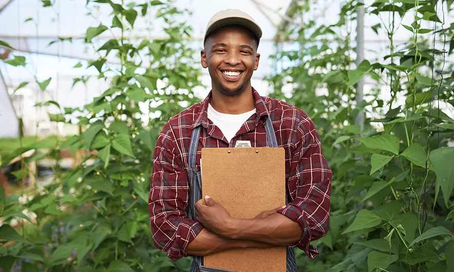 male business owner happily works after getting agricultural consultant insurance quote