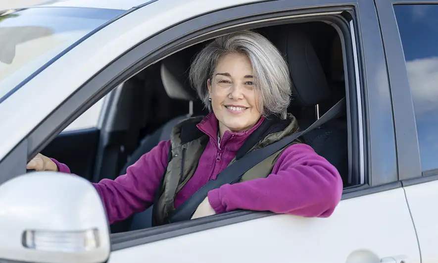 female customer pleased to be protected by auto insurance coverages