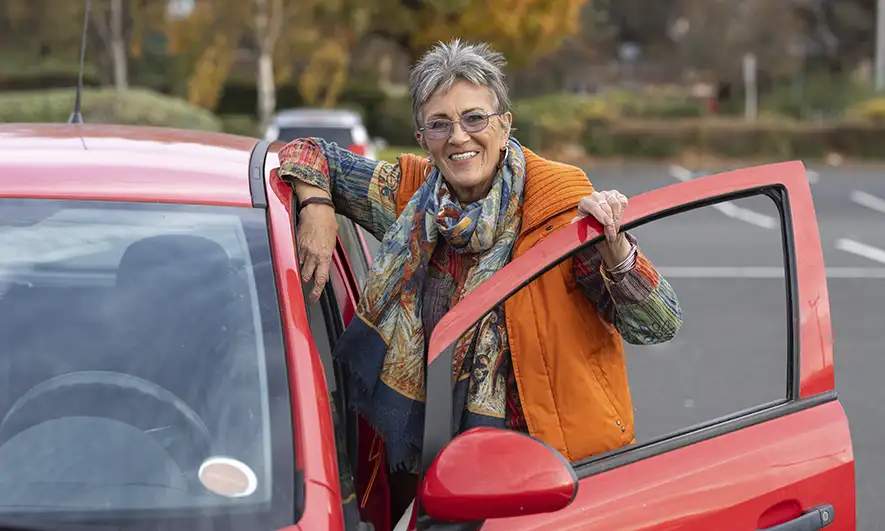 female driver happy to be protected by auto insurance pip from The Hartford