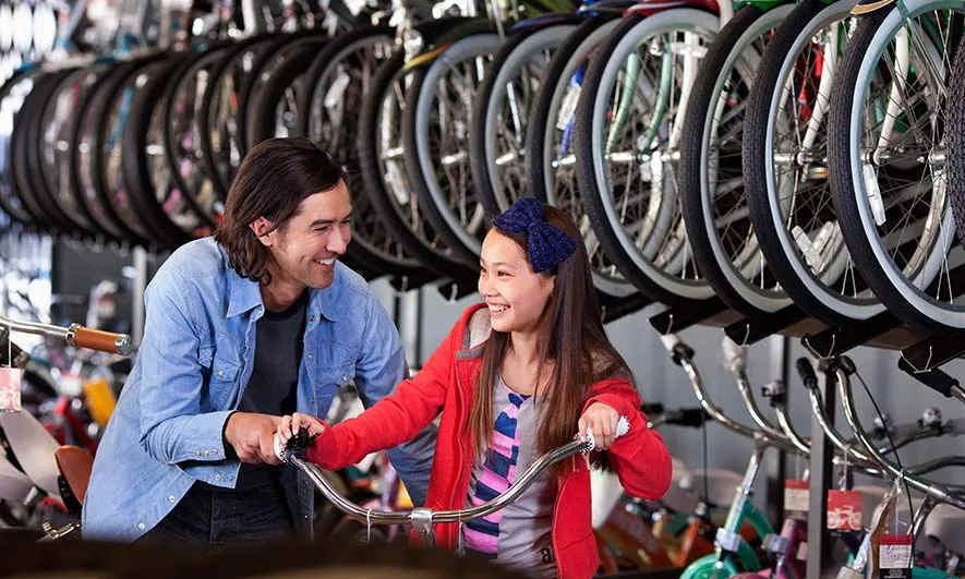 small business owner is happy after getting a bike shop insurance quote from The Hartford