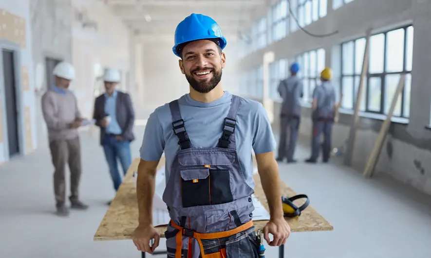Person in a hard hat inside a building under construction