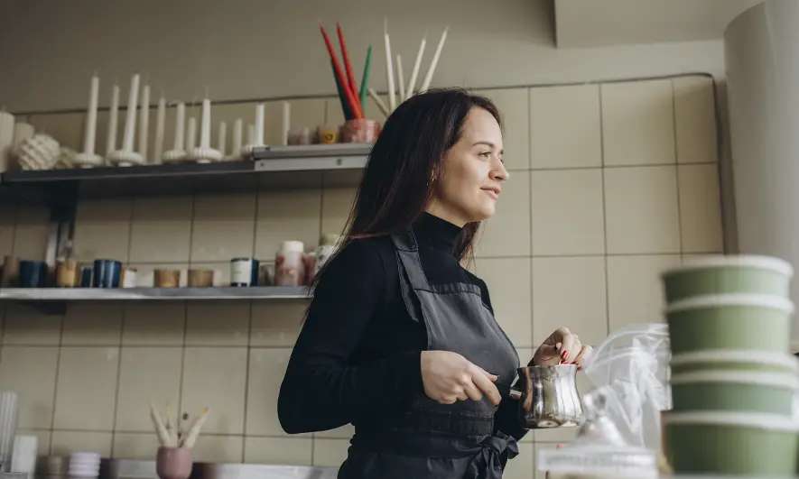 business owner happy to do her job while protected by candle business insurance