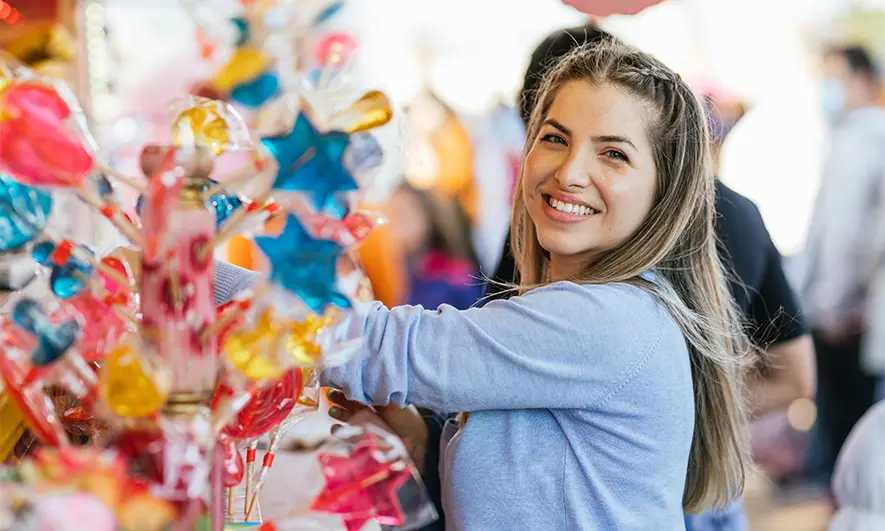 female business owner happily works after getting candy insurance quote
