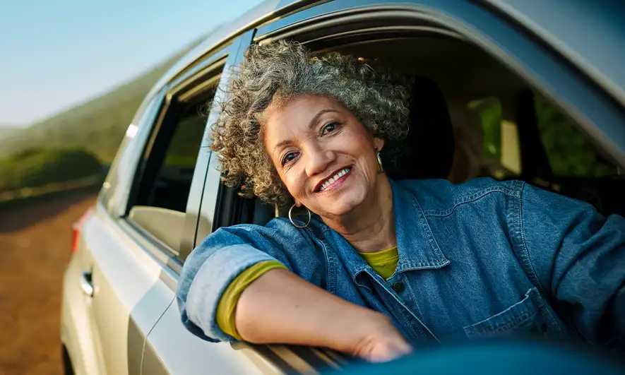 woman happy after getting car insurance for new car