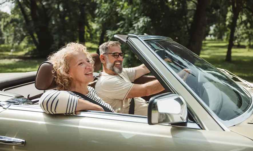 couple happy being protected by car insurance medical payments from The Hartford