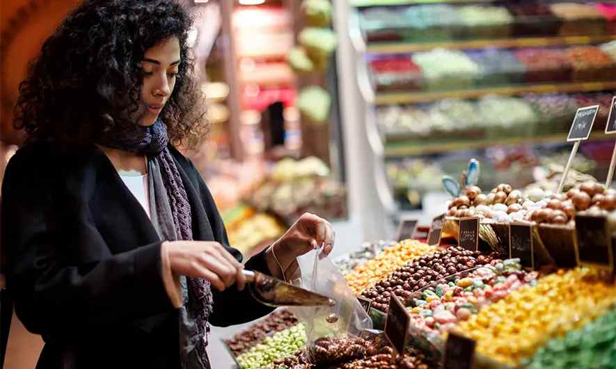 female small business owner happy to easily get coi for candy stores