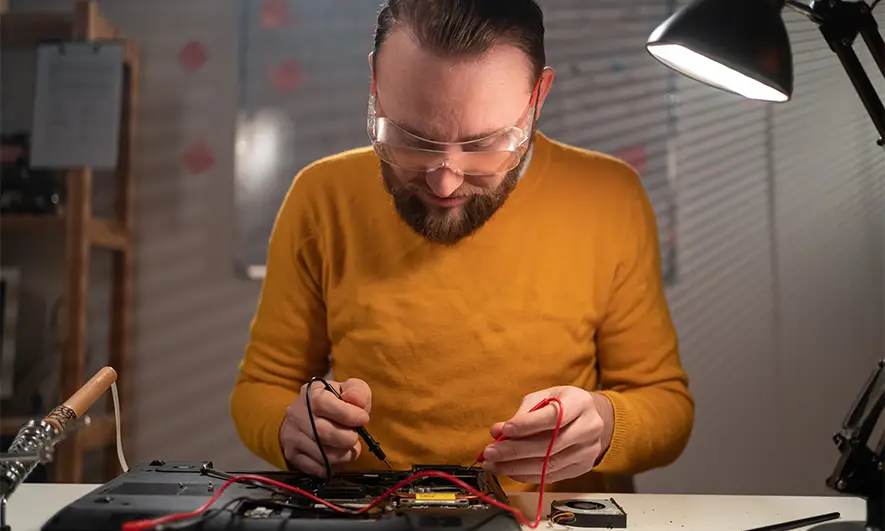 business owner happy to do his job after getting a computer repair insurance quote