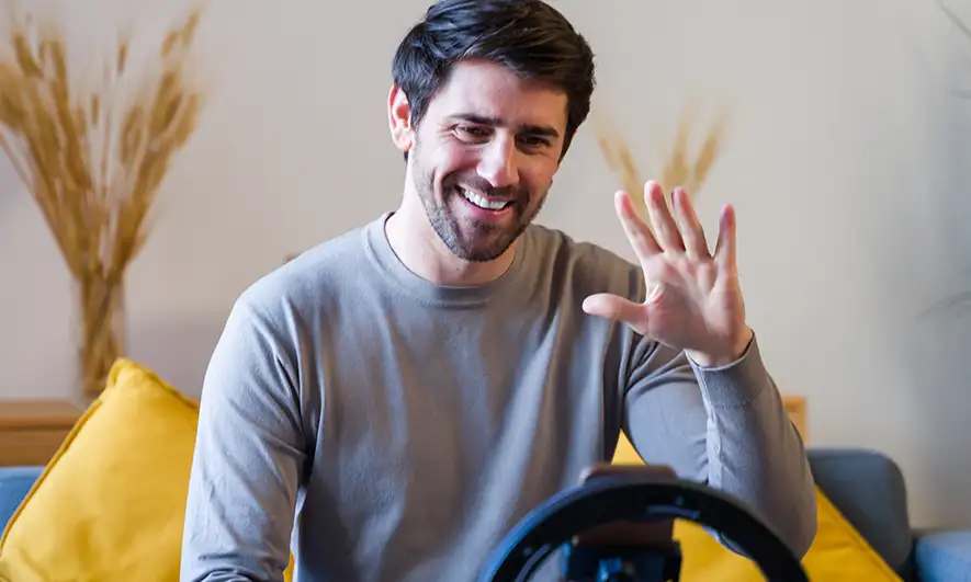 male business owner happily works after getting content creator insurance quote