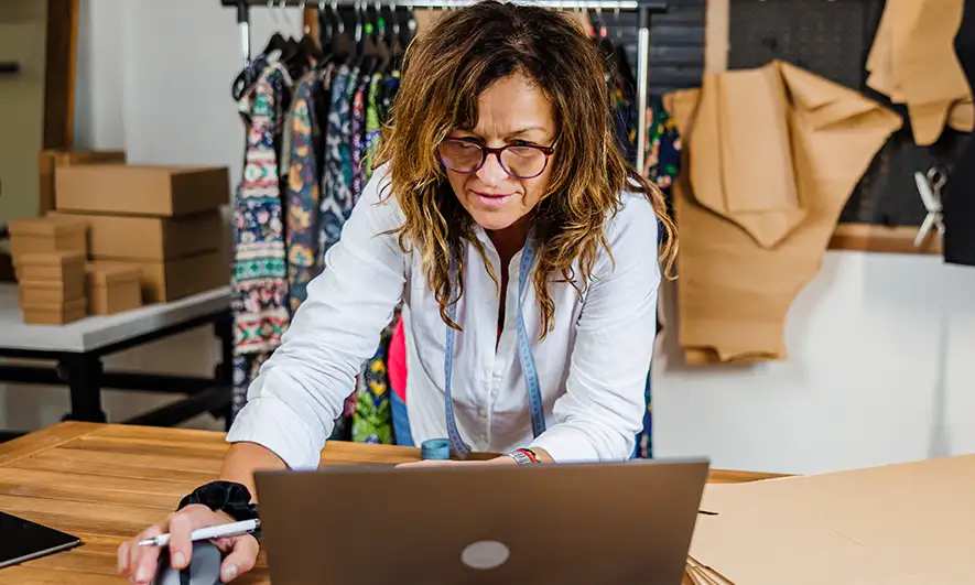 female small business owner researching a cyber crime insurance policy online