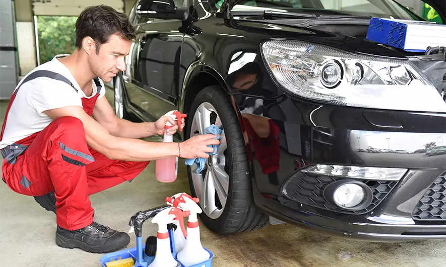 business owner happily does his job after getting detailing insurance