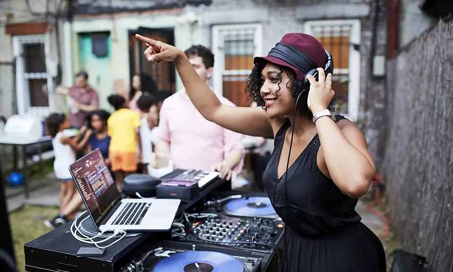 female small business owner protected by disc jockey insurance