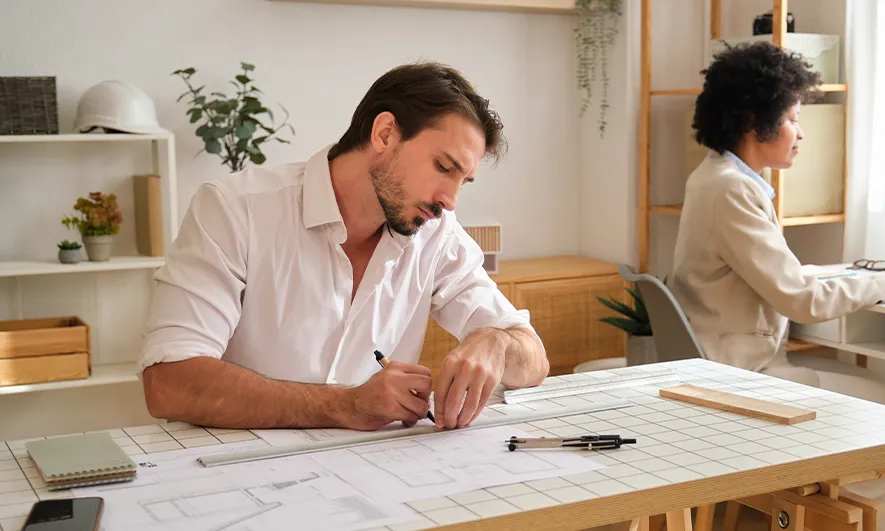 male and female business owners happily work after getting draftsman insurance quote