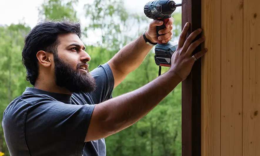 male small business owner happy to have fencing contractors insurance