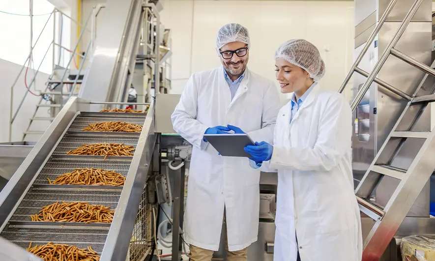 male and female business owners happy to do their jobs after getting a food manufacturers insurance quote