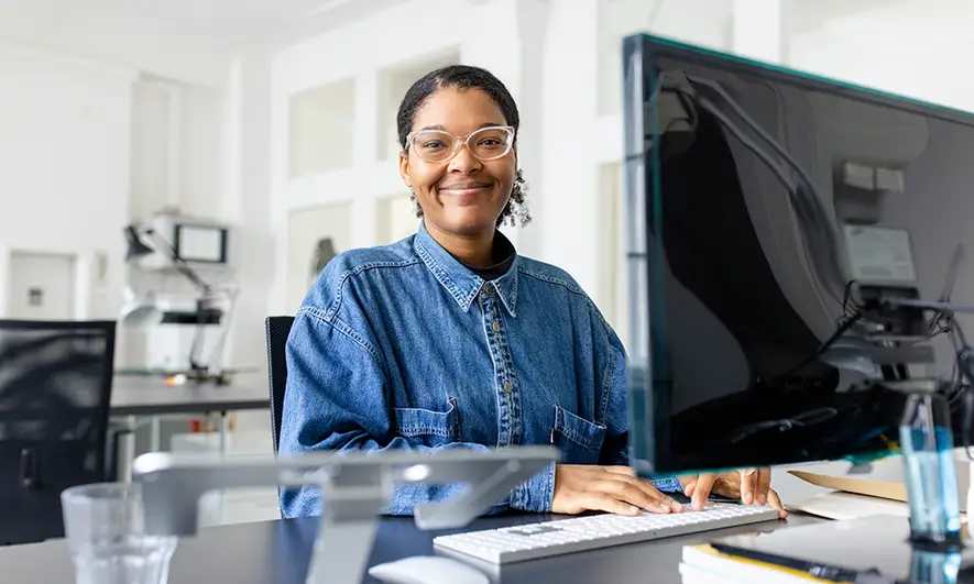 Woman sits at a laptop